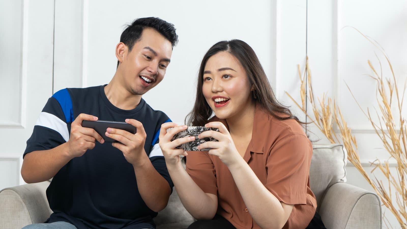 a manBuilding a winning AI neobank and woman sitting on a couch looking at a cell phone