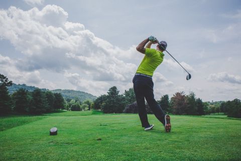 foto de homem balançando o taco de golfe